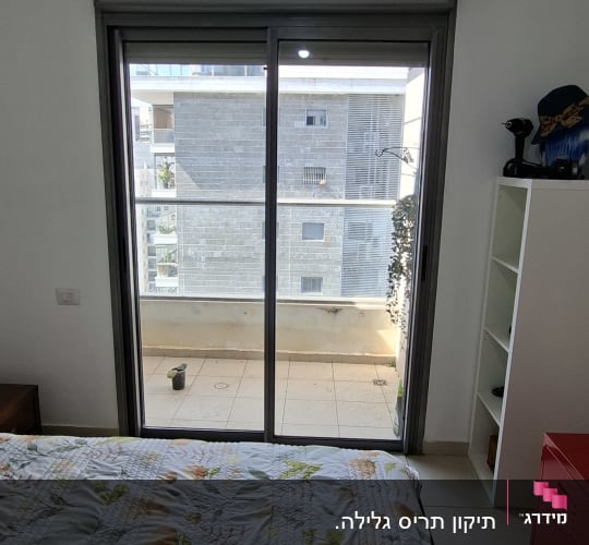חדר שינה עם חלון תריסים ומרפסת